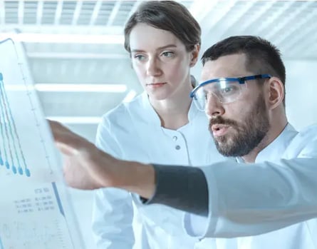 two scientists reading a screen discussing keto diet research two scientists reading a screen discussing keto diet research